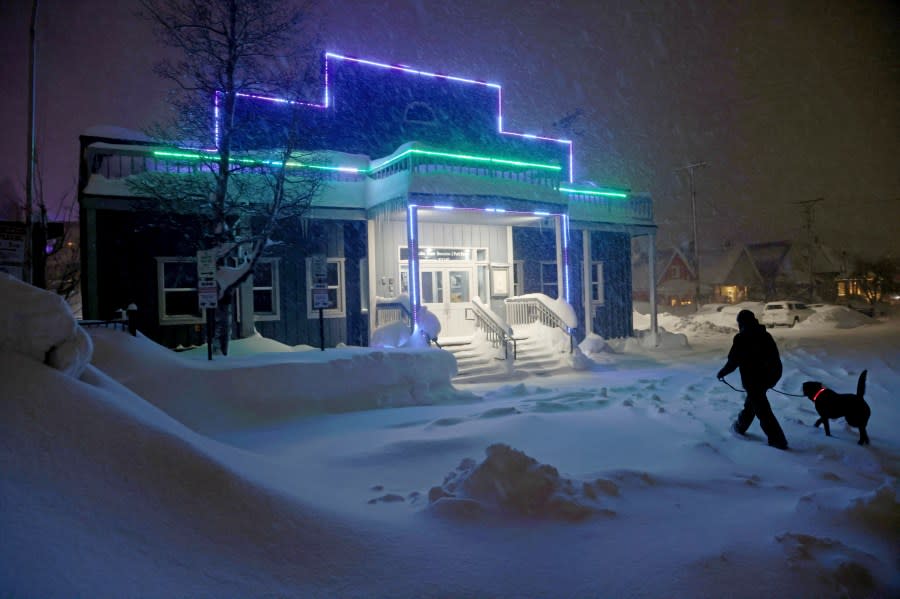 A man and his dog walk up to the Tahoe Donner Recreation and Park District’s Community Arts Center in downtown Truckee, Calif., Sunday, March 3, 2024. (Jane Tyska/Bay Area News Group via AP)