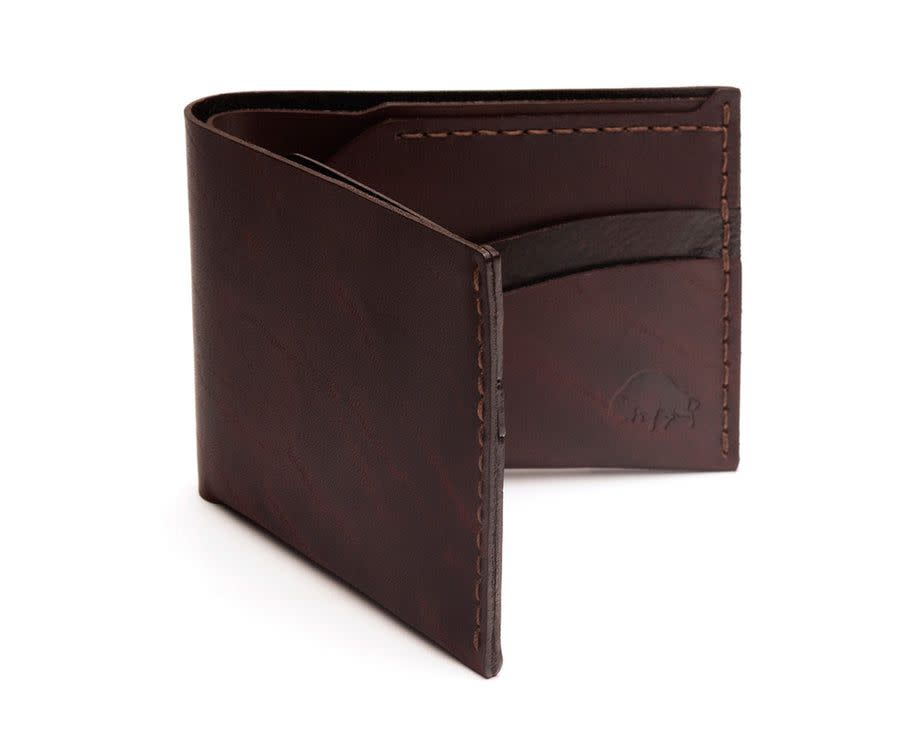 Brown Ezra Arthur wallet with small indentation depicting a bison.