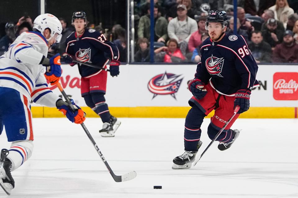 Mar 7, 2024; Columbus, Ohio, USA; Columbus Blue Jackets center Jack Roslovic (96) races toward Edmonton Oilers defenseman Brett Kulak (27) during the first period of the NHL hockey game at Nationwide Arena.