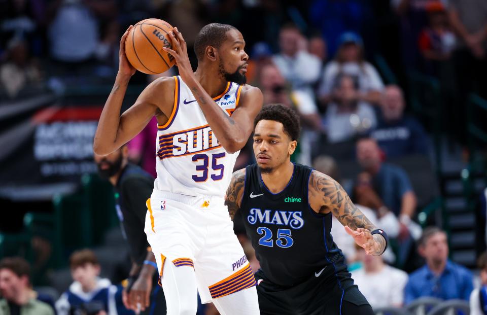 Phoenix Suns forward Kevin Durant (35) looks to score as Dallas Mavericks forward P.J. Washington (25) defends during the first quarter at American Airlines Center in Dallas on Feb. 22, 2024.