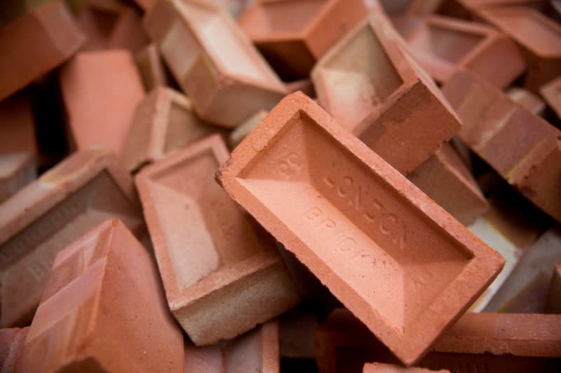 Bricks are seen at the Vauxhall depot of building material supplier Travis Perkins in London, Britain, October 25, 2013. REUTERS/Neil Hall/File Photo