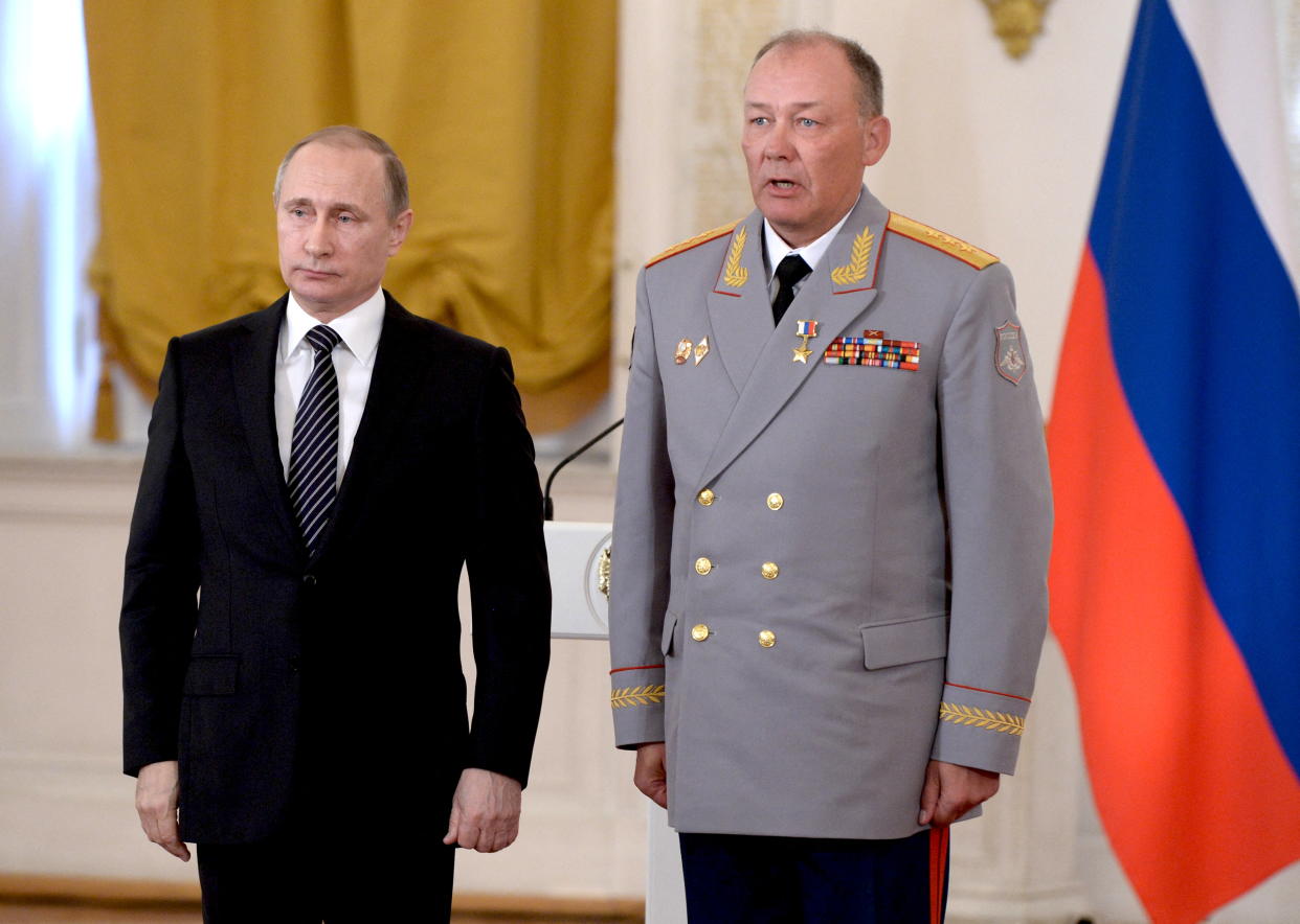 Russian President Vladimir Putin poses for a picture with first deputy commander of the Central Military district, colonel-general Alexander Dvornikov after he was awarded the title of Hero of the Russian Federation in Moscow, Russia March 17, 2016.  Pictures taken March 17, 2016.  Sputnik/Handout via REUTERS REUTERS  ATTENTION EDITORS - THIS IMAGE WAS PROVIDED BY A THIRD PARTY. NO RESALES. NO ARCHIVES. MANDATORY CREDIT