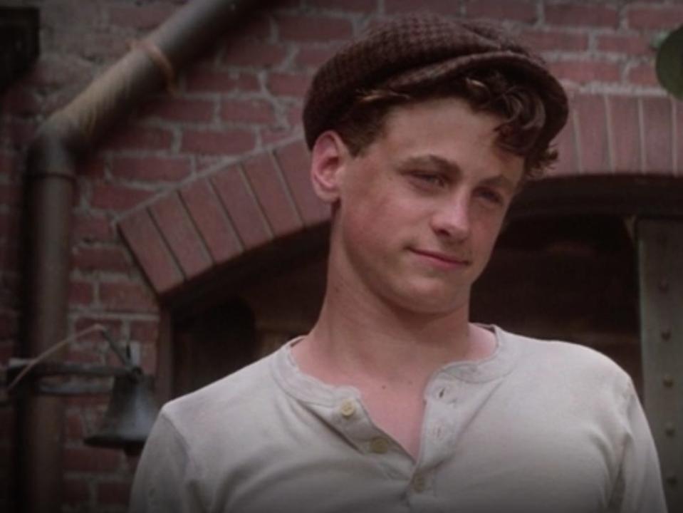 David Moscow as Davey in newsies in a white shirt and paperboy cap