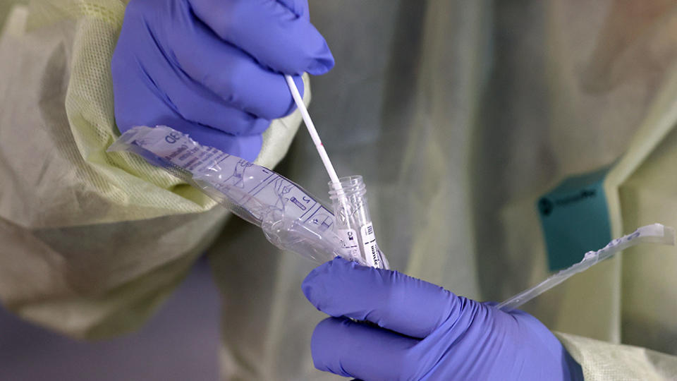 A doctor tests a patient for coronavirus