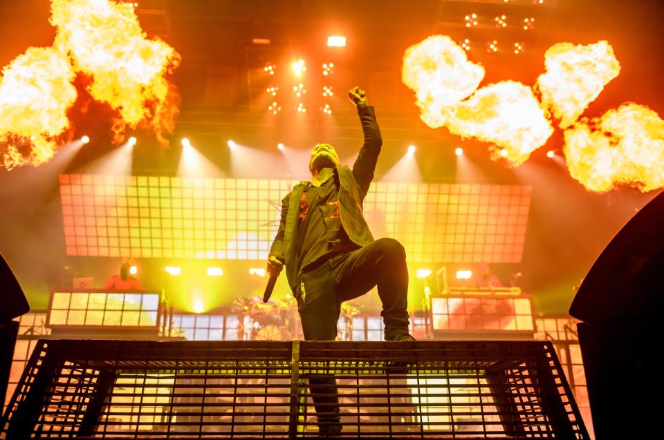 Corey Taylor, lead singer of the heavy metal band Slipknot, raises his fist as balls of flame erupt in the background during their show on April 7, 2022 at the Peoria Civic Center.