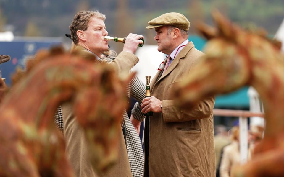 Racegoers drinking champagne on day one of the 2024 Cheltenham Festiva