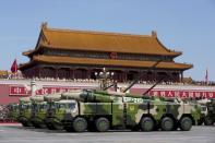 Chinese military vehicles carrying DF-21D anti-ship ballistic missiles, potentially capable of sinking a U.S. Nimitz-class aircraft carrier in a single strike, travel past Tiananmen Gate during a military parade to commemorate the 70th anniversary of the end of World War II in Beijing, in this September 3, 2015 file photo. REUTERS/Andy Wong/Pool/Files