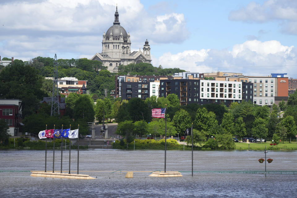 Rising water from the Mississippi River envelopes the riverbank, Wednesday, June 26, 2024, at Harriet Island Regional Park in St. Paul, Minn. (Anthony Souffle/Star Tribune via AP)