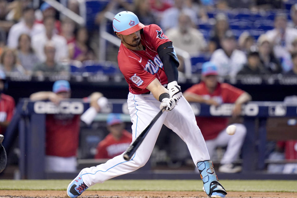 Miami Marlins' Adam Duvall hits a double during the first inning of a baseball game against the Atlanta Braves, Saturday, July 10, 2021, in Miami. (AP Photo/Lynne Sladky)