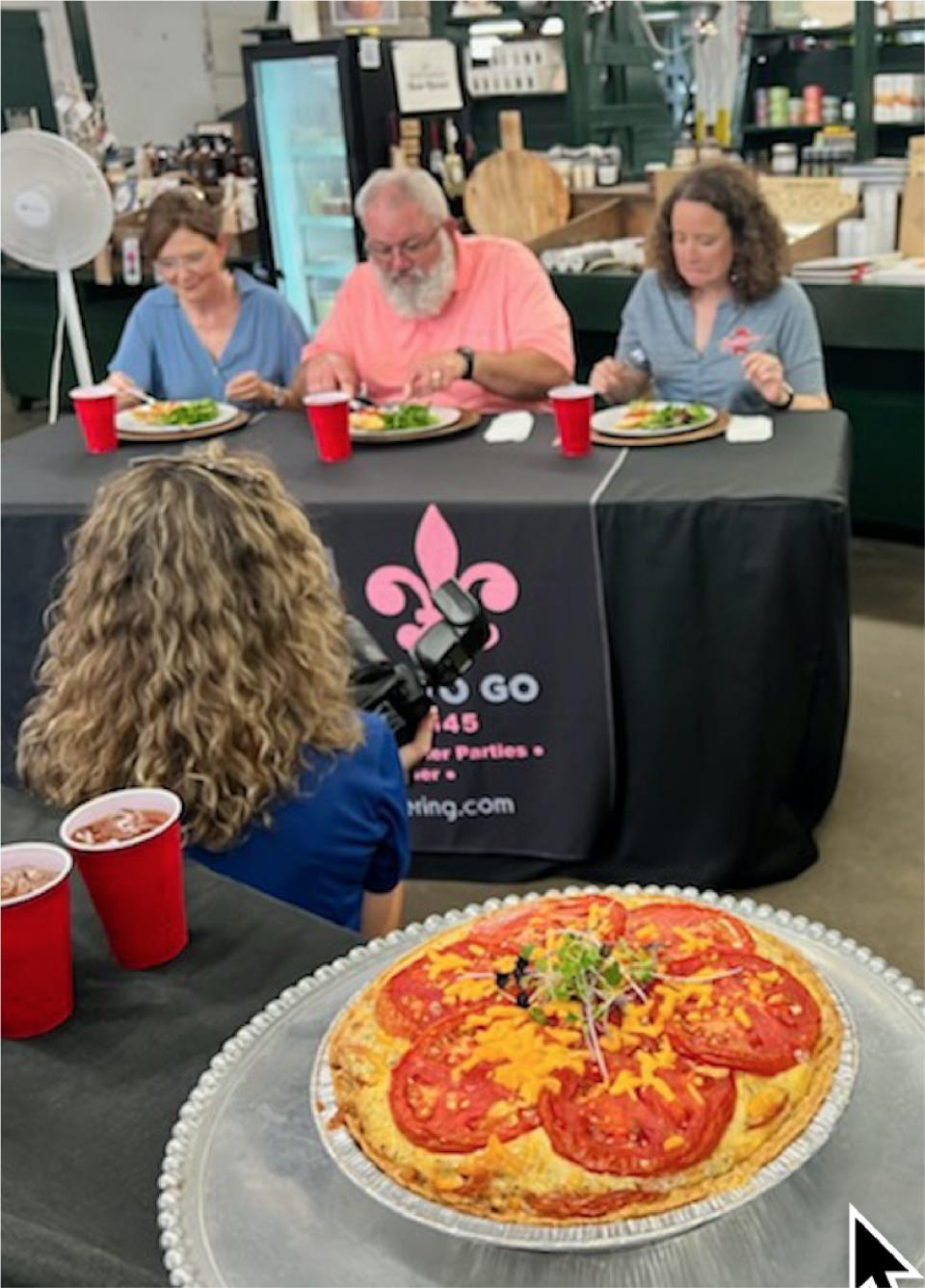 Judges taste chef Preston Williams' tomato pie at Montgomery Curb Market.