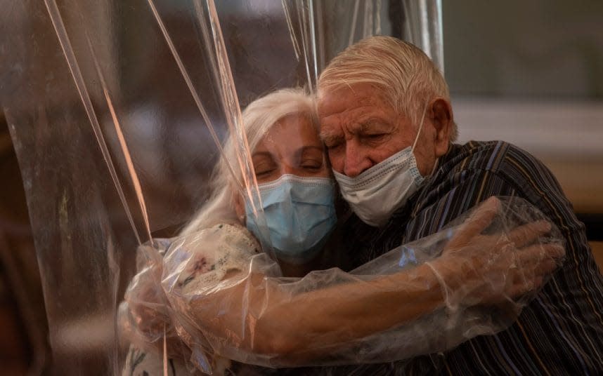 The Ballesol Fabra i Puig elderly care centre installed screens made of plastic film to resume relatives’ visits to residents, halted in mid-March. CREDIT: AP/EMILIO MORENATTI - AP/EMILIO MORENATTI