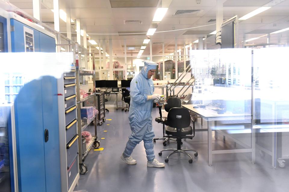 Employees head to the laboratory of Dutch company ASML, the world's largest supplier of semiconductor manufacturing equipment using photolithography systems, in Veldhoven on April 17, 2018. 