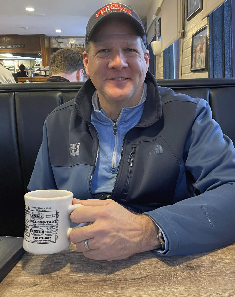 Republican New Hampshire Gov. Chris Sununu smiles while sipping a cup of coffee during an interview with the Associated Press, Thursday, March 2, 2023, in Laconia, N.H. Sununu, called the primary calendar shift “a horrible miscalculation” for President Joe Biden that exposes him to a legitimate primary challenge. “He’s made it harder to win in November '24 — if he’s the nominee,” Sununu said in an interview. “But because of what he did here, he very well may not be the nominee.” (AP Photo/Steve Peoples)