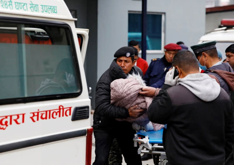 A body of a child who is among the eight Indian tourists who died due to suspected suffocation is being carried inside an ambulance while being taken for postmortem in Kathmandu