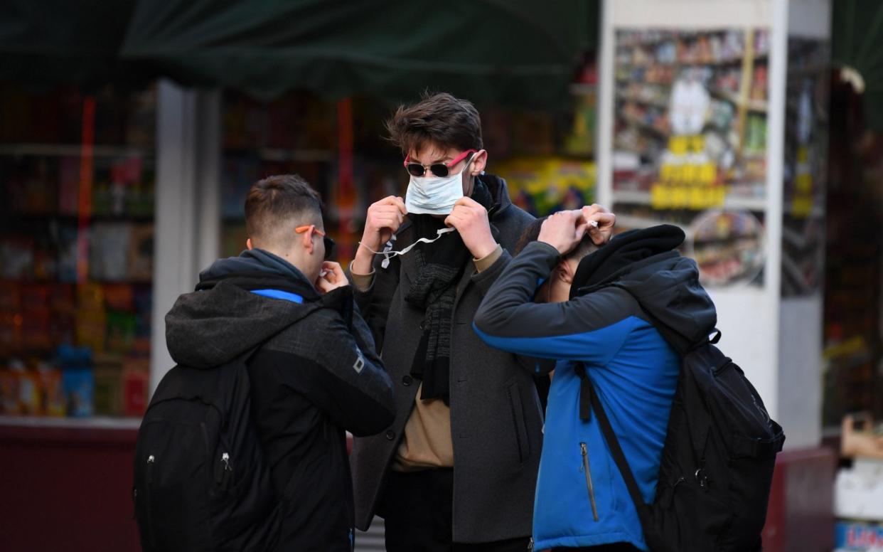 Tourists put on masks in London's Chinatwon - Daniel Leal-Olivas/AFP