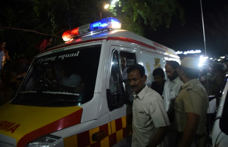 Supporters surround an ambulance carrying the remains of Tamil Nadu state leader Jayalalithaa Jayaram, in Chennai, on December 5, 2016