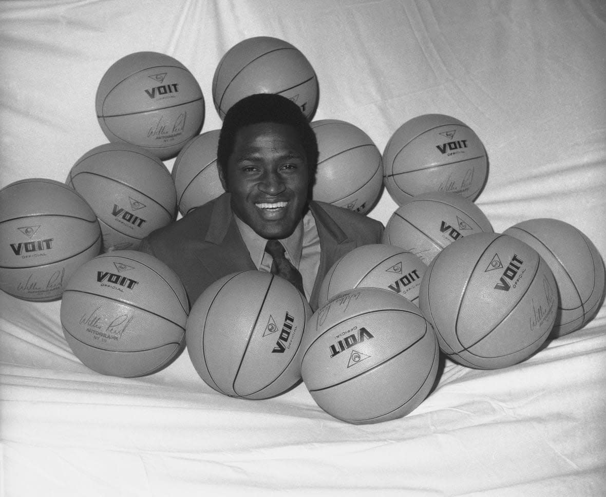 FILE – New York Knicks NBA player Willis Reed is surrounded by basketballs in New York, May 14, 1970, where he received his award as the NBAs Most Valuable Player. Willis Reed, who dramatically emerged from the locker room minutes before Game 7 of the 1970 NBA Finals to spark the New York Knicks to their first championship and create one of sports’ most enduring examples of playing through pain, died Tuesday, March 21, 2023. He was 80. Reed’s death was announced by the National Basketball Retired Players Association, which confirmed it through his family. (AP Photo/Anthony Camerano, File)