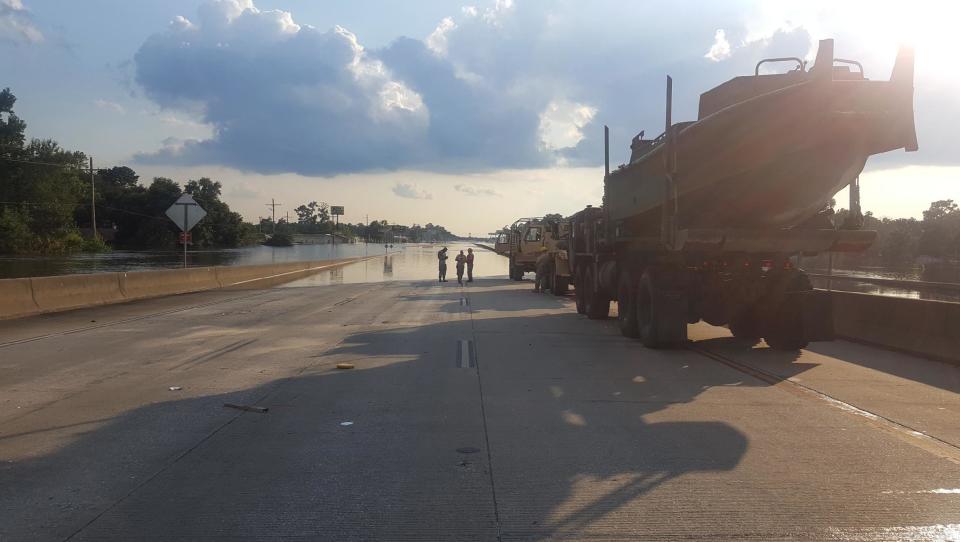 National Guard vehicles stop on Route 10 in Rose City.