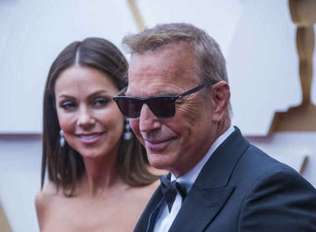 Kevin Costner's estranged wife wears Prada purse after begging