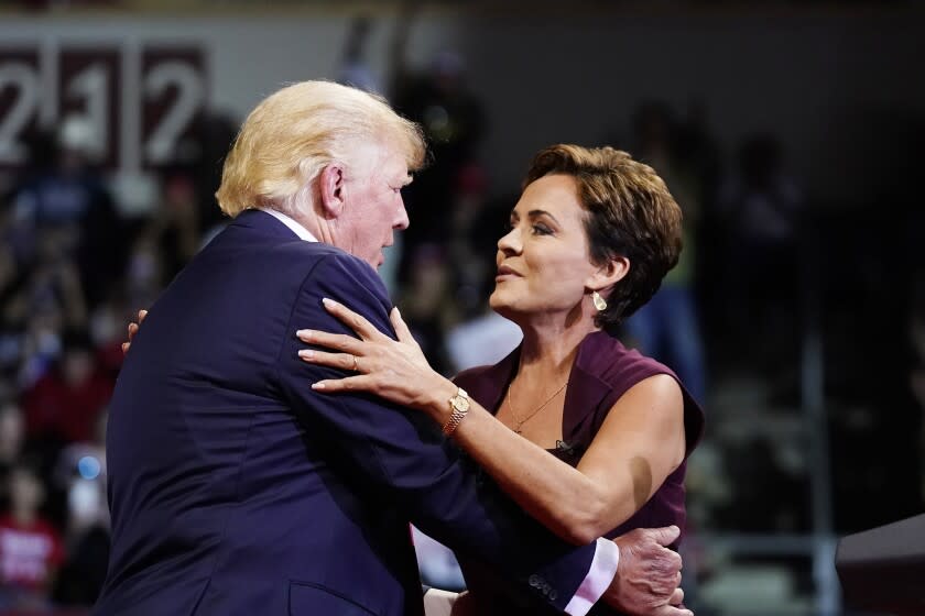 Former President Donald Trump, left, gives Kari Lake, who is running for the Republican gubernatorial nomination in Arizona, a hug as Trump speaks at a Save America rally Friday, July 22, 2022, in Prescott, Ariz. (AP Photo/Ross D. Franklin)