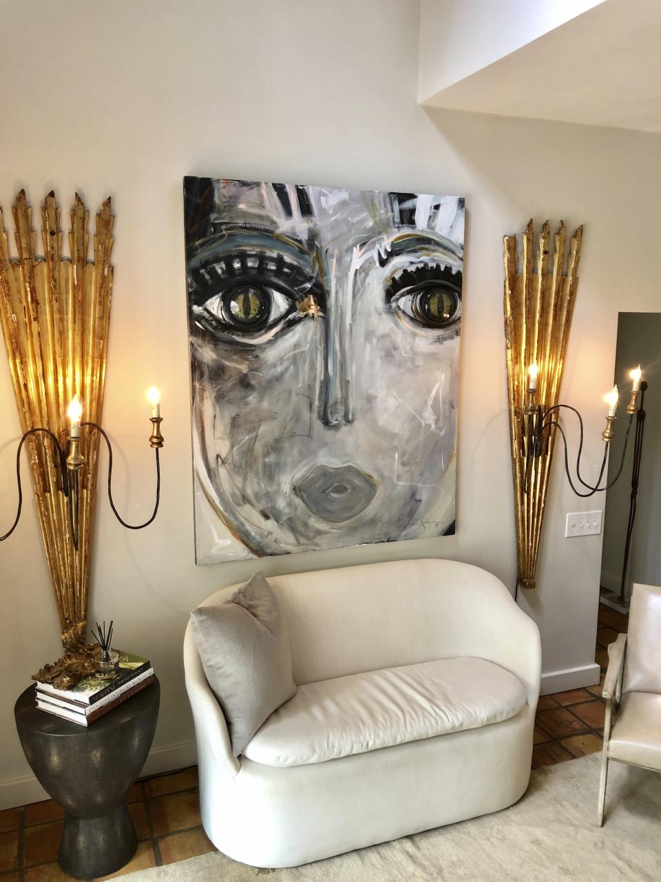 This photo provided by Windy O'Connor shows one of her "Chica" paintings hanging in her home in Charlotte, N.C. The fine artist often gives tiny versions of her paintings to friends as hostess gifts for the holidays. (Windy O'Connor via AP)