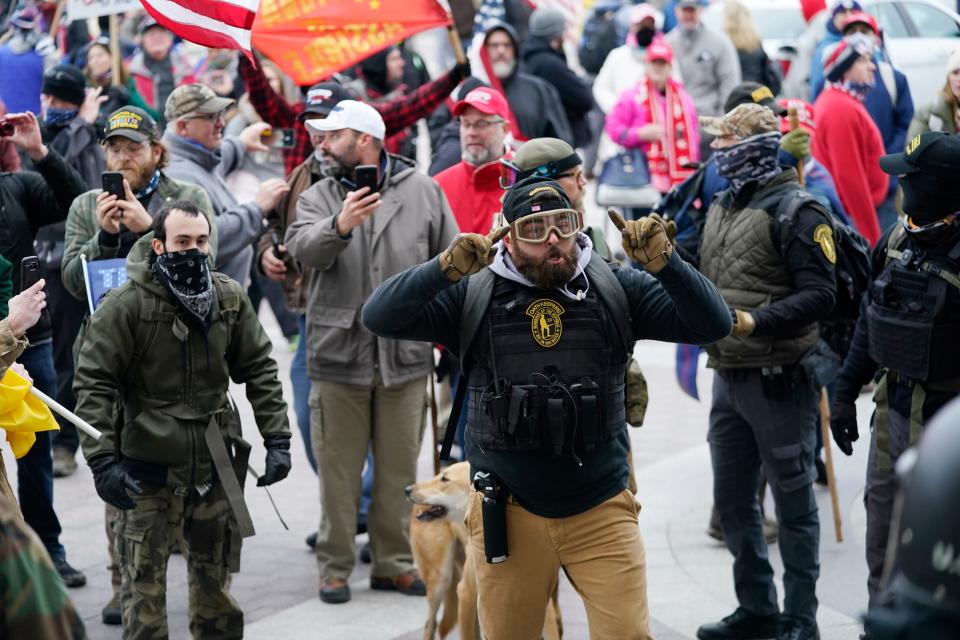 On Jan. 6, 2021, people with Oath Keepers patches gathered outside the U.S. Capitol in Washington.