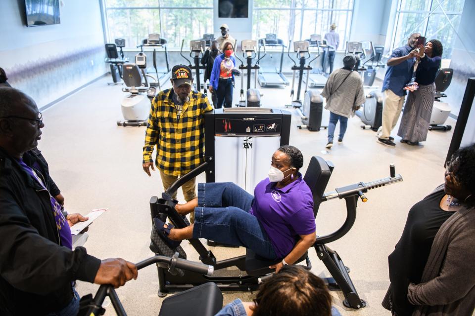 Jean Holman tries out some of the exercise equipment at the Bill Crisp Senior Center at 7560 Raeford Road on Tuesday, Oct. 25, 2022.