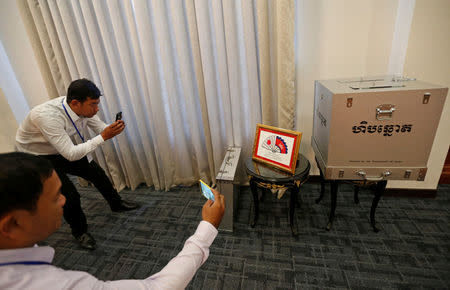 Journalists take photos of a ballot box donated by the Government of Japan at the Ministry of Foreign Affairs and International Cooperation in Phnom Penh, Cambodia February 21, 2018. REUTERS/Samrang Pring