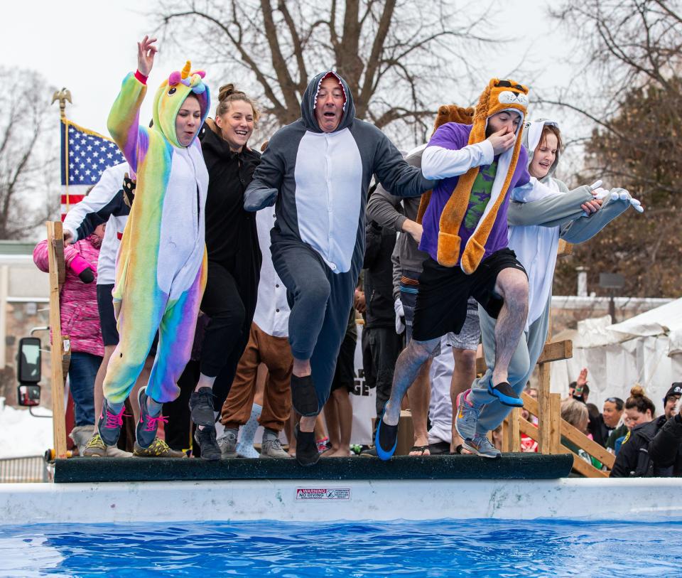 Participants jump into a frigid pool during the 5th annual Milwaukee Zoo Polar Plunge on Saturday, Feb. 15, 2020. Proceeds from the event benefit Special Olympics Wisconsin athletes.