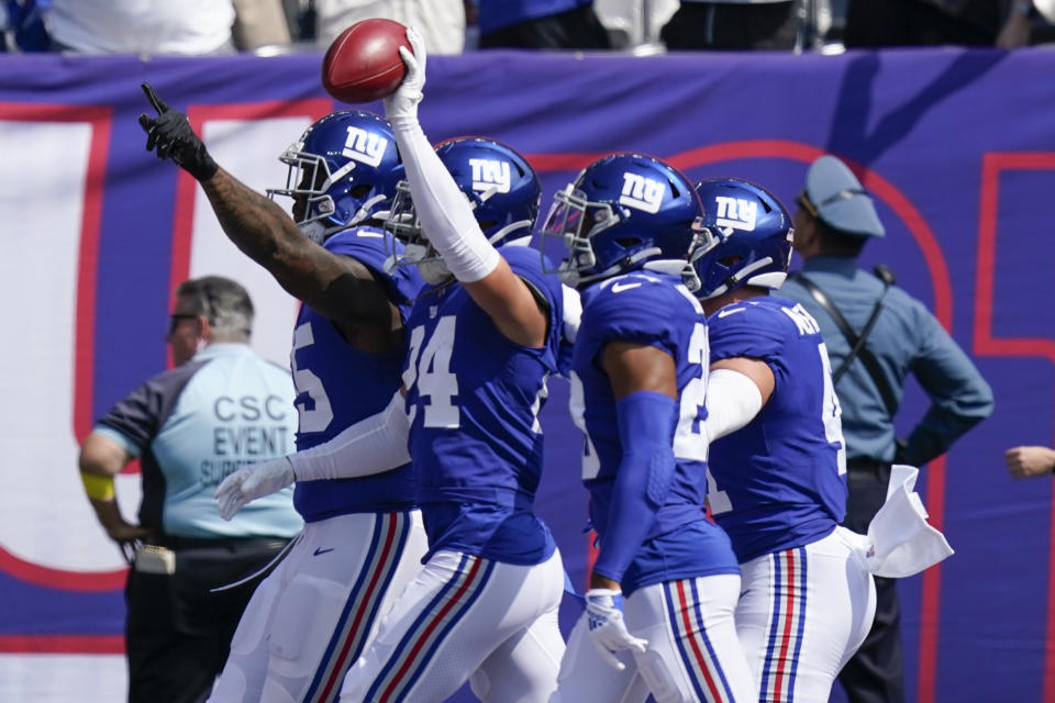 New York Giants' Dane Belton (24), second from left, reacts after recovering a fumble during the kick off during the first half an NFL football game against the Carolina Panthers, Sunday, Sept. 18, 2022, in East Rutherford, N.J. (AP Photo/Seth Wenig)