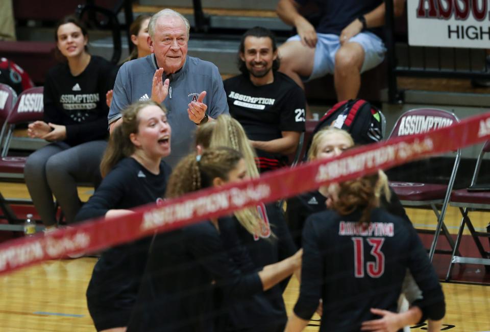 Assumption head coach Ron Kordes applauds his team as they scored a point against Mercy during their match at the Assumption High School gym in Louisville, Ky. on Sept., 2022.  Assumption won 3-1.
