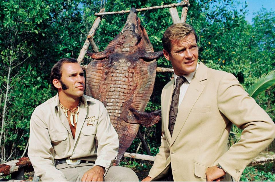 Trespassers will be eaten: Roger Moore (right) with crocodile wrangler Ross Kananga