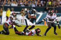 Philadelphia Eagles wide receiver DeVonta Smith (6) runs with the ball past Tampa Bay Buccaneers Ross Cockrell, bottom, Mike Edwards, right, and Jordan Whitehead during the second half of an NFL football game Thursday, Oct. 14, 2021, in Philadelphia. (AP Photo/Matt Rourke)