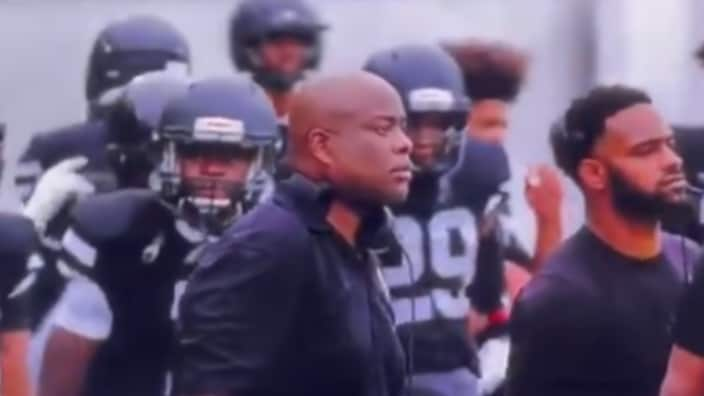 Coach Roy Johnson (center) and the team from Bishop Sycamore, a reported high school in Ohio, are shown during their game against IMG Academy on Sunday, which wrapped up this year’s Geico ESPN High School Football Kickoff. (ESPN)