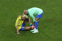 Brazil's Neymar, left, cries as his teammate Dani Alves hugs him after their loss in the World Cup quarterfinal soccer match against Croatia, at the Education City Stadium in Al Rayyan, Qatar, Friday, Dec. 9, 2022. (AP Photo/Alessandra Tarantino)