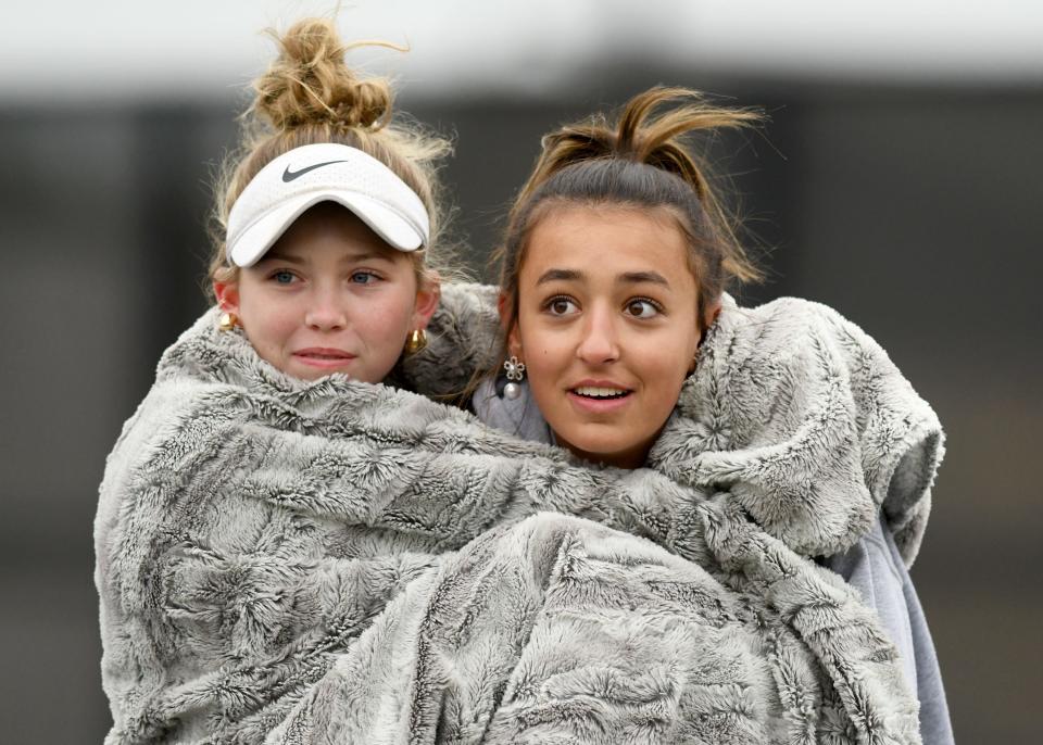 Hoover No. 1 seed team of Addie Sheil and Ema Papcke warm up on a cold morning during play against Jackson fourth seed doubles Anisha Rawa and Isha Nagajothi in Girls tennis Division I doubles sectional semifinals at Jackson Park Courts. Saturday, Oct. 7, 2023.