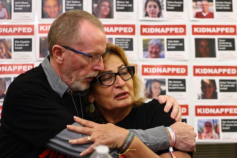 Orit Meir, mother of hostage Almog Meir, hugs Thomas Hand, father of hostage Emily Hand, during a press conference at the embassy of Israel in London on Nov. 20, 2023.