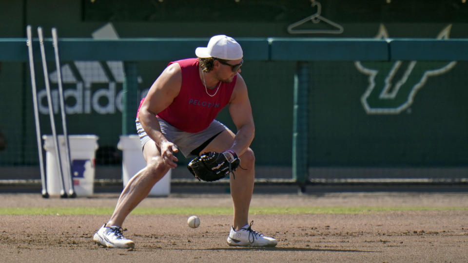 New York Yankees infielder Luke Voit fields a ground ball during informal baseball workouts at the University of South Florida Thursday, Feb. 24, 2022, in Tampa, Fla. (AP Photo/Chris O'Meara)