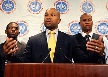 Players Association president Derek Fisher is flanked by Chris Paul and Maurice Evans at a news conference after labor talks broke down