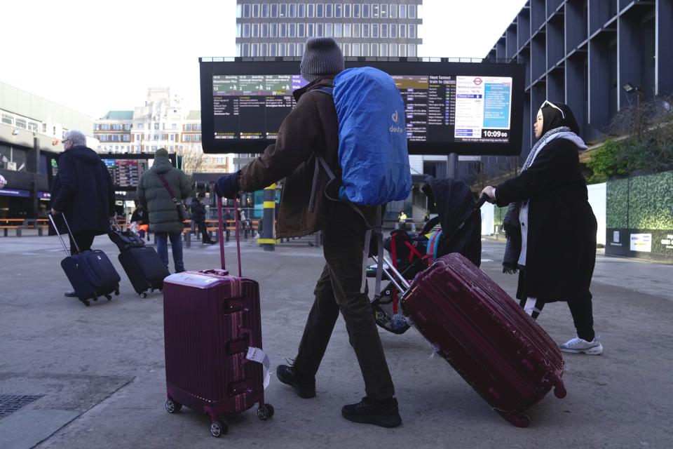 Passengers arrive at the Euston Station in London, Monday, Jan. 22, 2024. The U.K.'s Met Office weather service had issued an unusual blanket wind warning for the whole country before Storm Isha, which reached its peak overnight. A 99-mile-an-hour gust was recorded at Brizlee Wood radar station in northeastern England. (AP Photo/Kin Cheung)