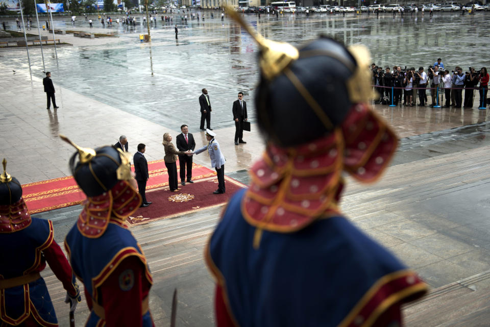 U.S. Secretary of State Hillary Rodham Clinton, center left, is greeted during an arrival ceremony at the Government House Monday, July 9, 2012 in Ulan Bator, Mongolia. (AP Photo/Brendan Smialowski, Pool)