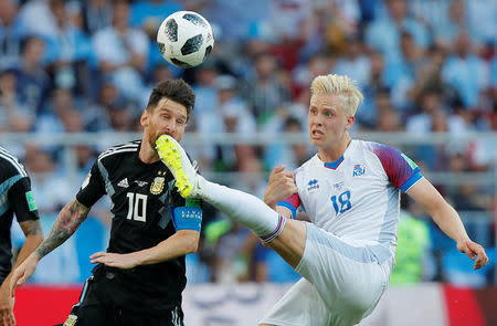 Soccer Football - World Cup - Group D - Argentina vs Iceland - Spartak Stadium, Moscow, Russia - June 16, 2018 Argentina's Lionel Messi in action with Iceland's Hordur Bjorgvin Magnusson REUTERS/Maxim Shemetov