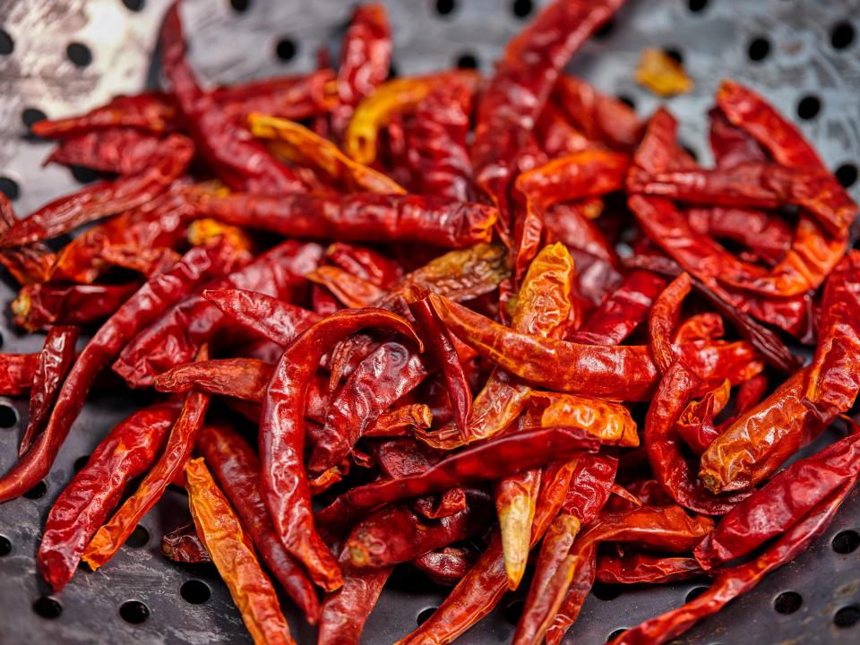 a lot of Red chili peppers in silver bowl