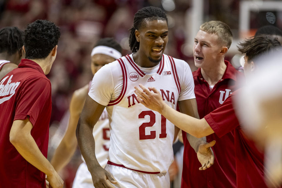 Indiana forward Mackenzie Mgbako (21) reacts with his teammates as he walks to the bench during a timeout in the first half of an NCAA college basketball game against Kansas, Saturday, Dec. 16, 2023, in Bloomington, Ind. (AP Photo/Doug McSchooler)