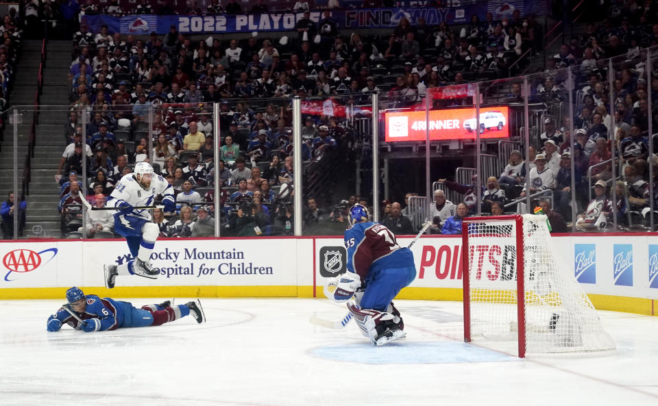 Tampa Bay Lightning center Steven Stamkos (91) jumps over Colorado Avalanche defenseman Erik Johnson (6) as Avalanche goaltender Darcy Kuemper (35) watches the puck during the second period of Game 1 of the NHL hockey Stanley Cup Final Wednesday, June 15, 2022, in Denver. (AP Photo/John Locher)