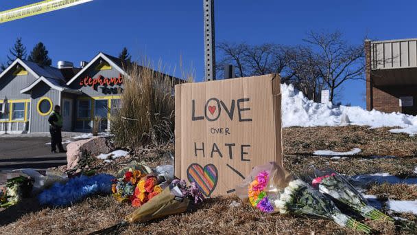 PHOTO: Bouquets of flowers and a sign reading 'Love Over Hate' are left near Club Q, an LGBTQ nightclub in Colorado Springs, Colo., Nov. 20, 2022.  (Jason Connolly/AFP via Getty Images)