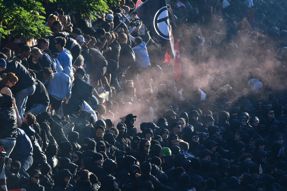 <p>Protesters flee after riot police stormed the “Welcome to Hell” rally against the G-20 summit in Hamburg, northern Germany on July 6, 2017. (Photo: Boris Roessler/AFP/Getty Images) </p>