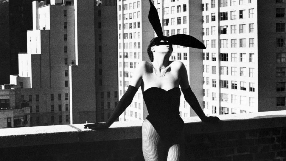 Newton often contrasted intimate evening outfits against the harsh light of day, as demonstrated here with "Elsa Peretti as a Bunny," where the philanthropist and jewellery designer wears a Halston bunny costume on a roof terrace in New York, 1975. - Helmut Newton Foundation