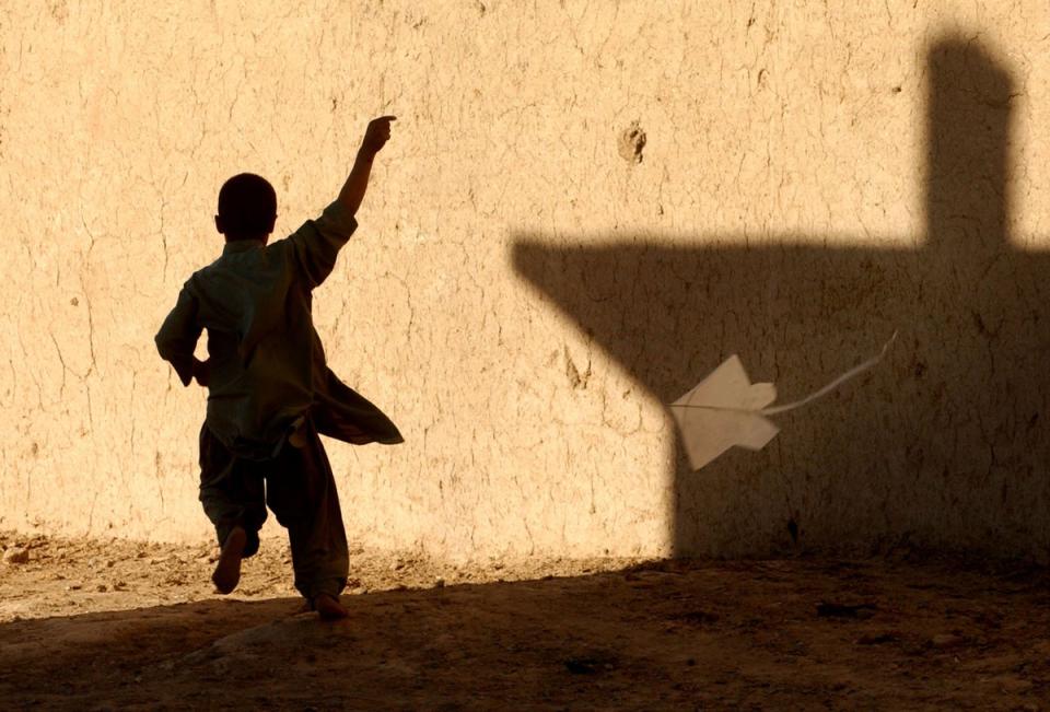 A young Afghan boy flies a kite in a refugee district of Quetta, Pakistan (Getty Images)