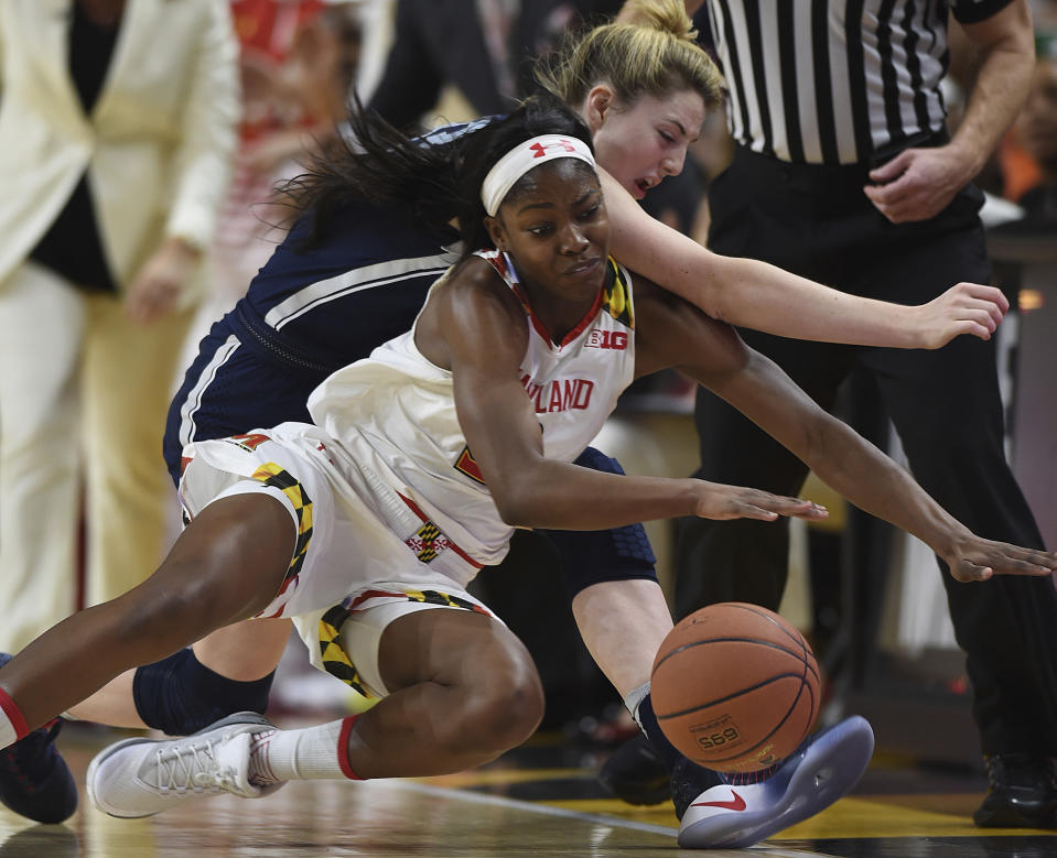 Maryland's Kaila Charles, left and Connecticut's Katie Lou Samuelson chase thee ball during the first half of an NCAA college basketball game, Thursday, Dec. 29, 2016, in College Park, Md. (AP Photo/Gail Burton)